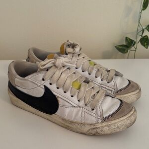 Nike White Sneakers with Black Swoosh and Yellow Tongue Accents